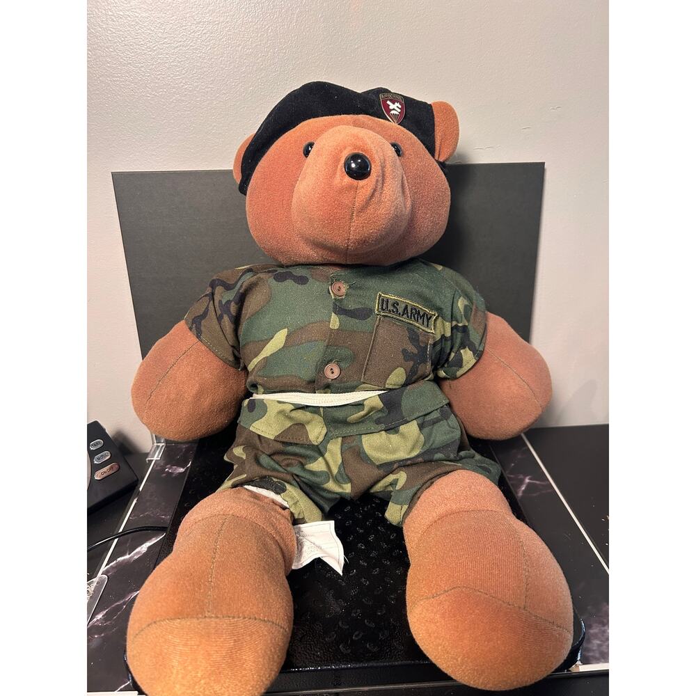 vintage teddy bear in a U.S. Army camouflage uniform and black beret